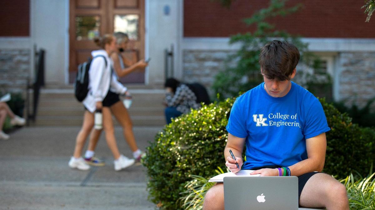 Sonny Martin of Lexington, Ky., a freshman at the University of Kentucky in Lexington, studies outside on the first day of classes for the fall semester Monday, Aug. 23, 2021.
