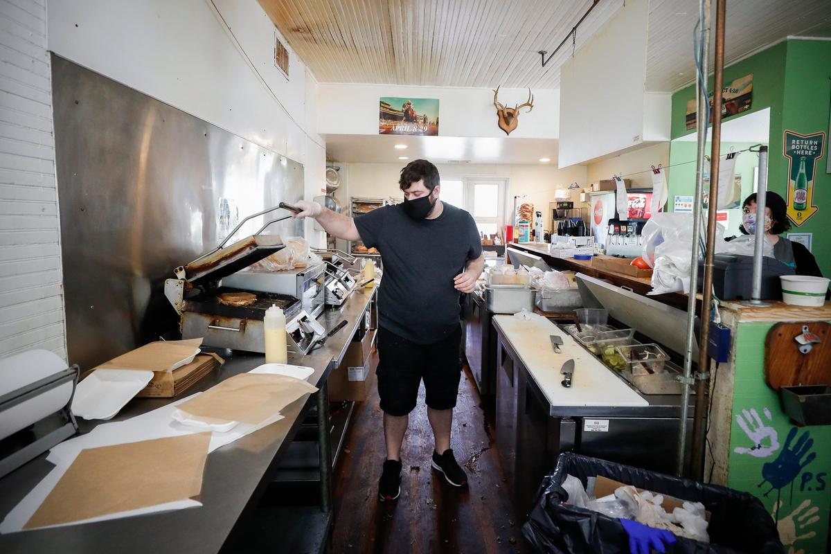Wallace Station general manager Dante Galtieri works the sandwich press at Wallace Station. Wallace Station is currently offering call ahead takeout orders and opens at 11 a.m. every day except Tuesday.
