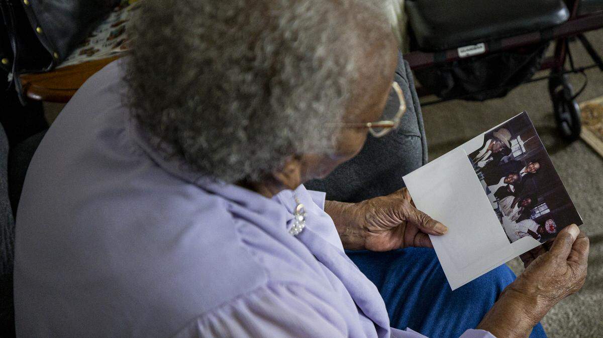 Nora Williams looks at a photo on Thursday, Aug. 7, 2025, at her house in Lexington, Ky.