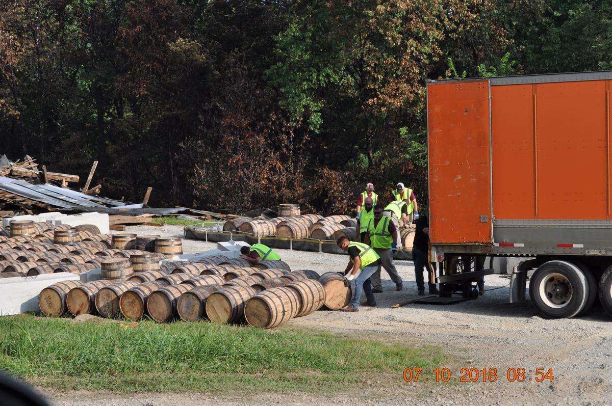 After the barrels are retrieved and repaired, if necessary, they are loaded onto a truck for removal from the site of the collapsed warehouse.