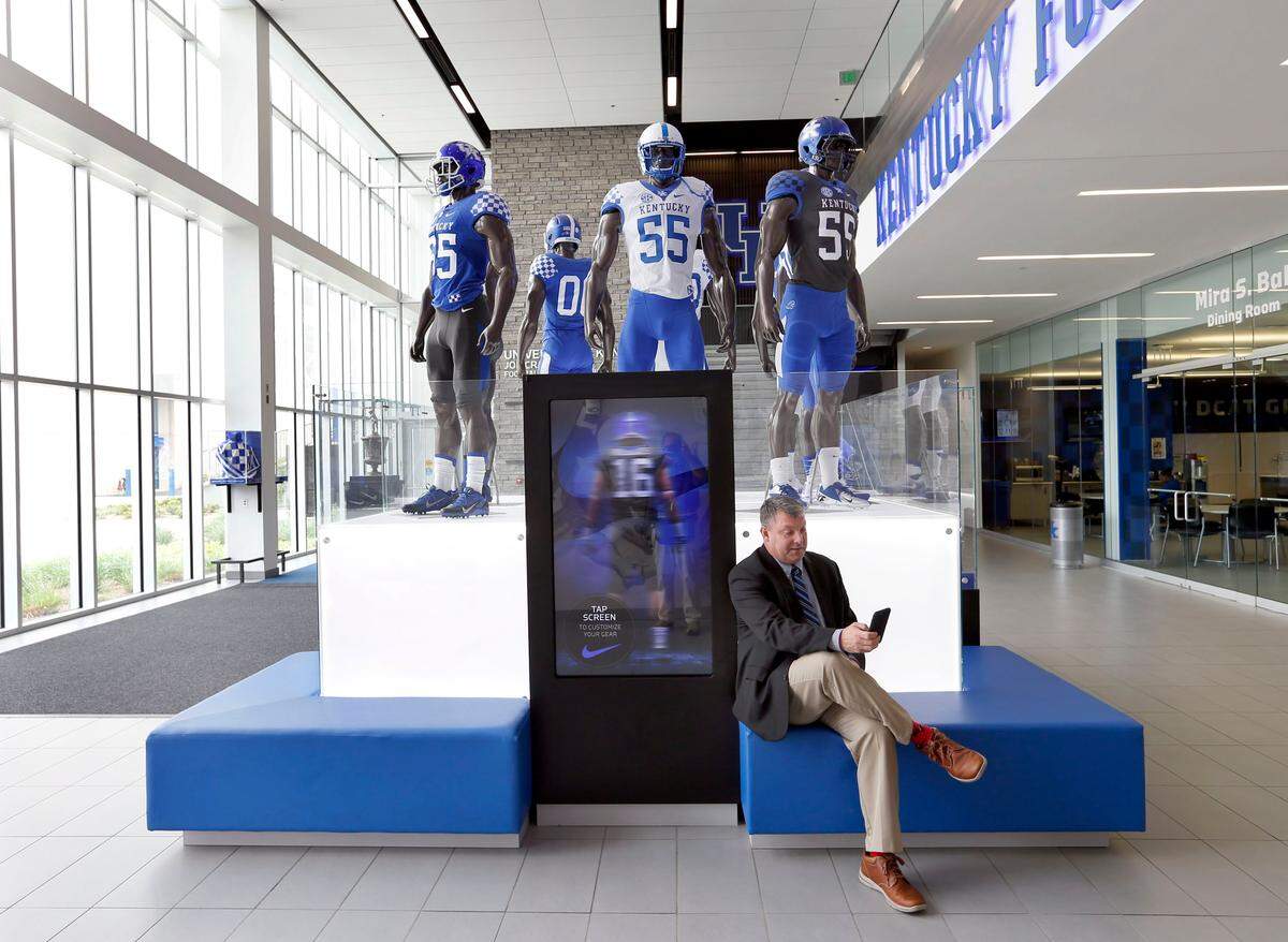 UK’s director of player development Freddie Maggard checked his phone as he waited for a former teammate to join him at the practice facility this summer. “I want (former players) around and I want them part of it,” UK Coach Mark Stoops said of Maggard’s position. “Freddie has a connection to a lot of them and no one knows the history more than him.”