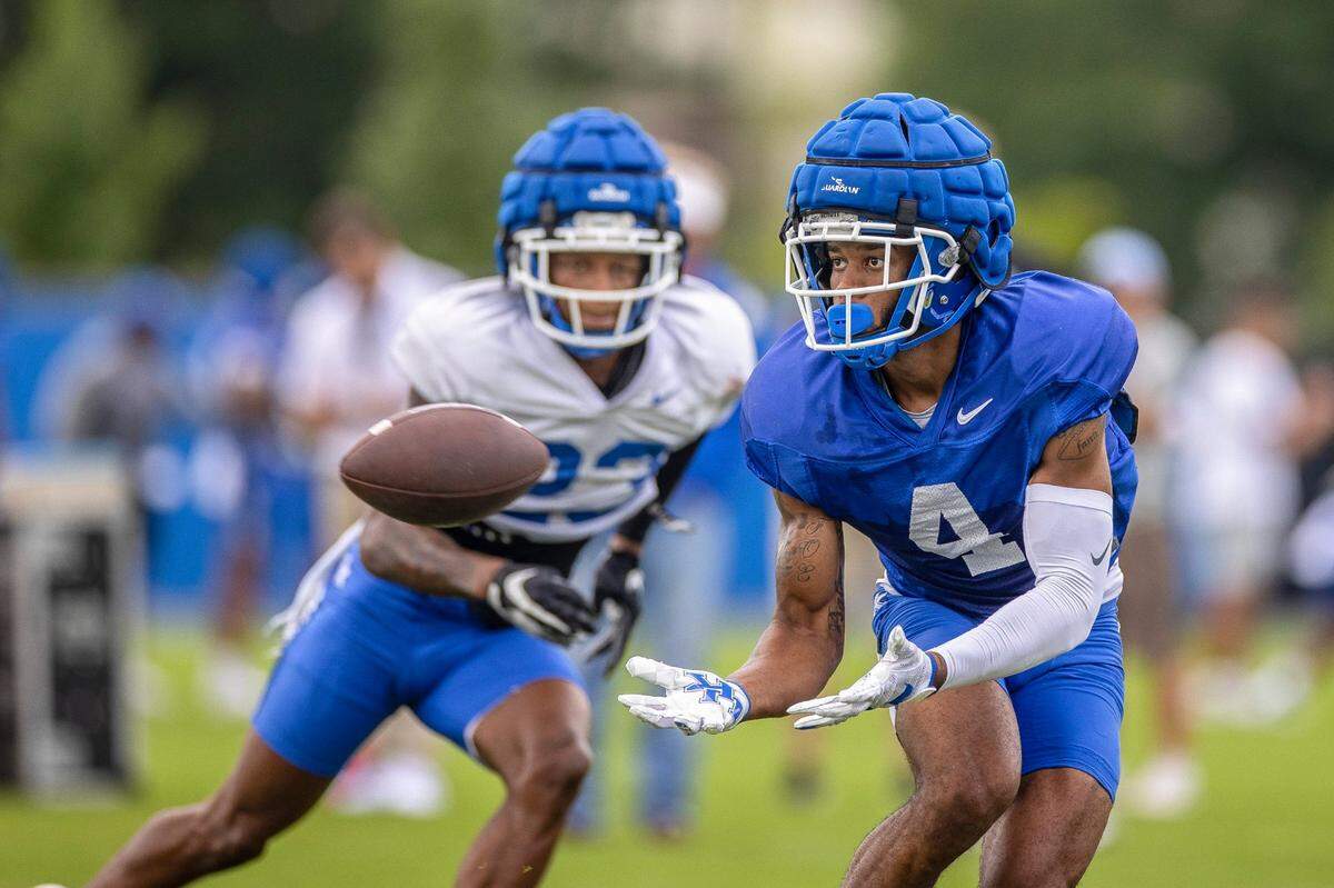 DeMarcus Harris (4) reaches to catch a pass during University of Kentucky’s football Fan Day and open practice at the Joe Craft Football Training Center practice fields on the UK campus in Lexington, Ky., on Saturday, Aug. 6, 2022.