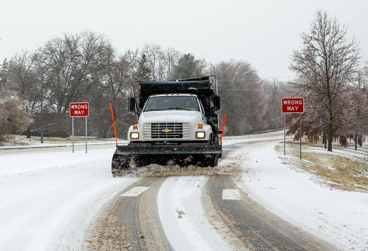 A Kentucky Department of Transportation snow plow clears Tates Creek Road at Alumni Drive in Lexington, Ky. Friday morning, Feb. 4, 2022 after an overnight winter storm of ice, sleet and snow blanketed the city.