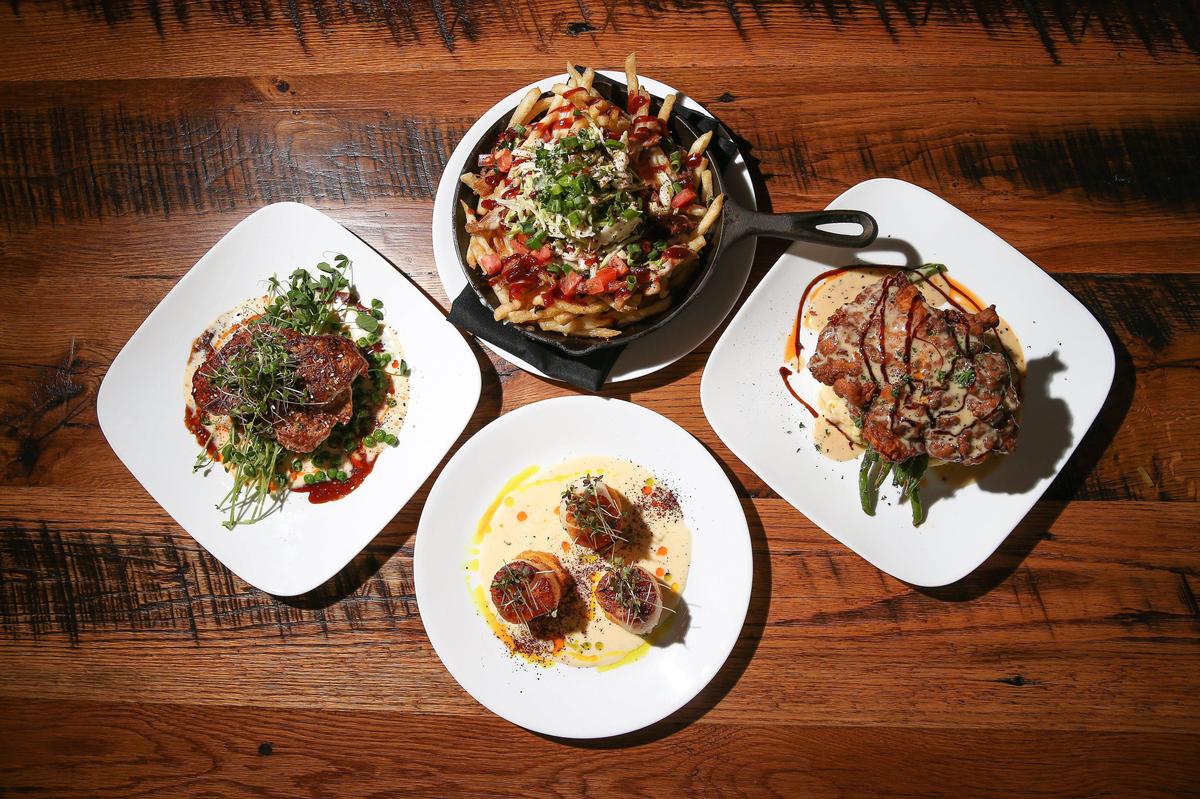 Clockwise from left, pork tenderloin, Carolina fries, fried chicken and a scallop starter at Graze.