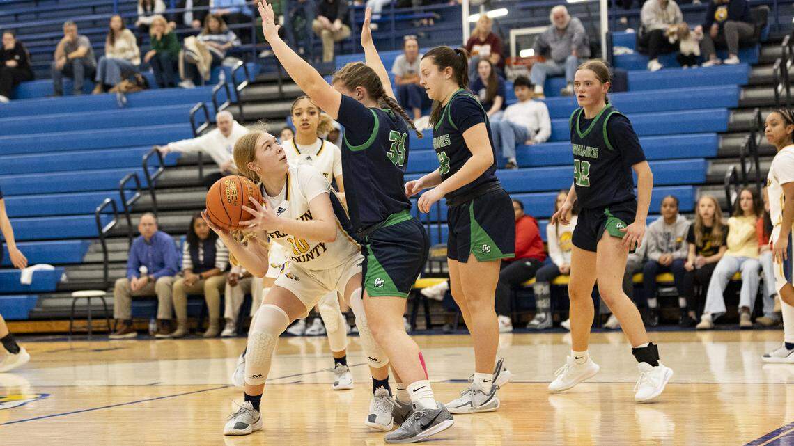 Franklin County’s Haylee Hazelett (10) sizes up the basket against the defense of Great Crossing’s Emery Corrigan (33) during the Flyers’ 57-52 win on Tuesday at Franklin County High School in Frankfort.
