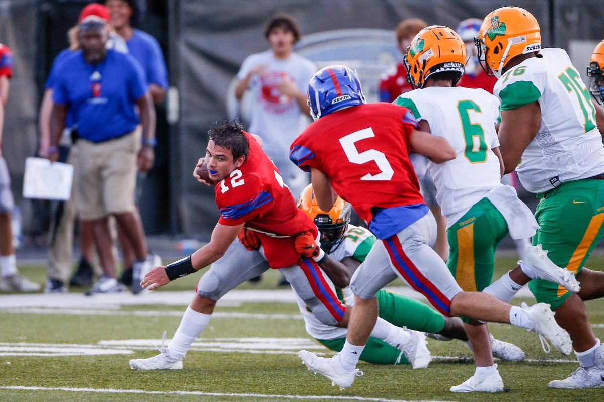 Mercer County’s Jackson Peavler (12) lost his helmet while running with the ball against Bryan Station on Saturday night.