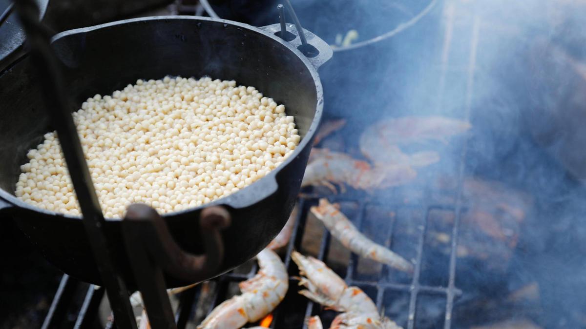 Pearl couscous cooks above fresh caught prawns from the Louisiana gulf on Tuesday, July 25, 2023 at Bourbon Barrel Cottages in Lawrenceburg, Ky.