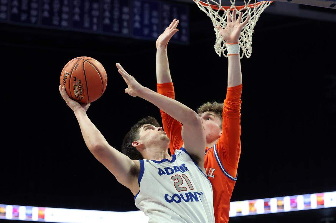 Adair County’s Brayton Coomer (21) fought off Marshall County’s Ryan Stokes on Wednesday night. Coomer finished with 10 points and four rebounds.