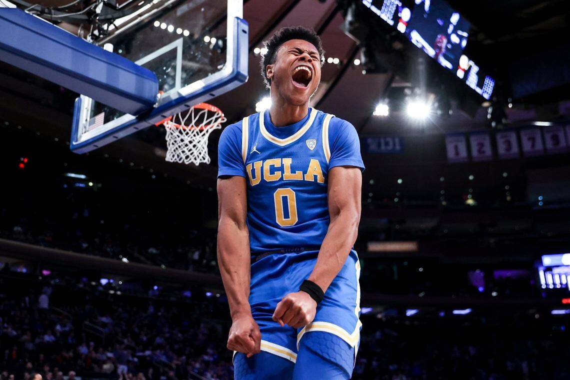 UCLA guard Jaylen Clark reacts after a slam dunk during the second half of an NCAA college basketball game against Kentucky in the CBS Sports Classic, Saturday, Dec. 17, 2022, in New York. The Bruins won 63-53. (AP Photo/Julia Nikhinson)