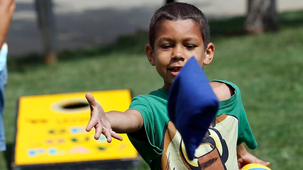 Paul White, 7, tossed a bean bag as Lexington Parks and Recreation helped kids experience the magic of summer camp with the Park and Play van. The van visits various Lexington parks, including the stop Tuesday morning in Phoenix Park, with activities such as slip and slides, sprinklers, dodgeball, tug of war, craft projects, cornhole, and more. Some of the parks the van will visit include Cardinal Valley Park, Douglass Park Green Acres Park, Lou Johnson Park, Martin Luther King, and Woodhill Park.