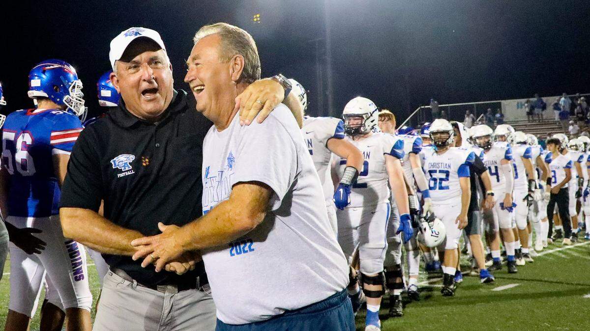 Lexington Christian head coach Doug Charles, left, congratulates Madison Central’s Mike Holcomb on his 300th career win after Friday night’s game. Holcomb became the 13th coach in Kentucky high school football history to win 300 games.