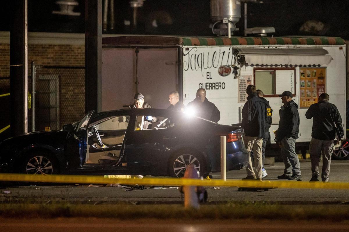 Members of law enforcement investigate the scene where a Lexington police officer and another person were reportedly shot near Deja Vu on New Circle Road.