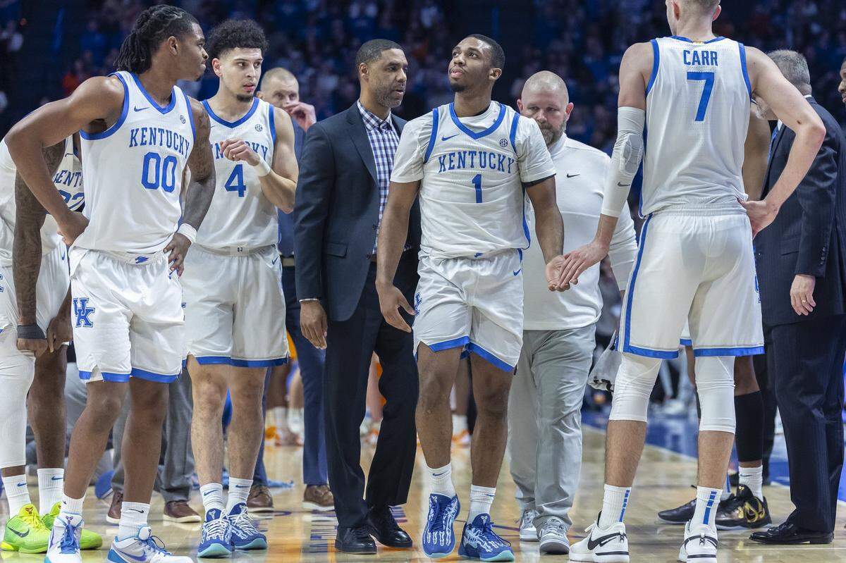 Kentucky teammates look on as Lamont Butler leaves the Rupp Arena court after suffering a shoulder injury in a win over No. 5 Tennessee on Tuesday night.