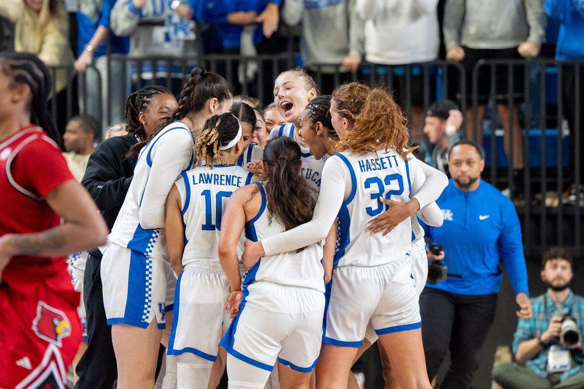 Kentucky players celebrate their 71-61 overtime win over Louisville on Saturday night. The Wildcats (4-0) are back in action Monday night in Memorial Coliseum.