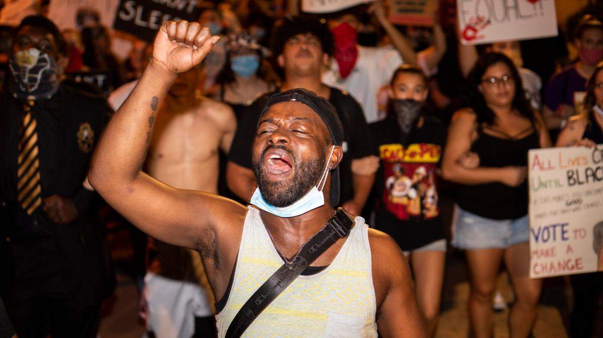 Hundreds of people march through downtown during the ninth night of protesting police violence in Lexington, Ky., Saturday, June 6, 2020.