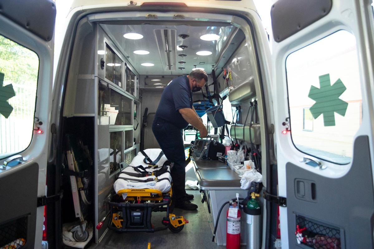 Dwayne Oliver, a Lee County EMT, prepares an ambulance for the next run after transporting a patient to a medical center in Breathitt County, Ky., on Tuesday, Sept. 7, 2021.