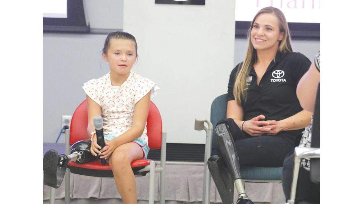 Katie Eddington, Georgetown para athlete, left, and Oksana Masters, U.S. Paralympian and Team Toyota athlete answer questions Toyota employees asked Thursday.
