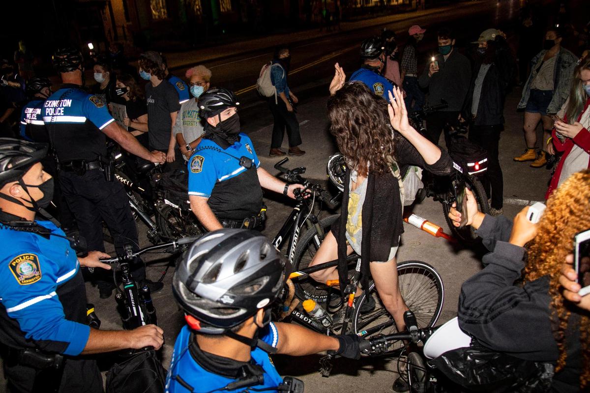 Police confront protesters on Ave of Champions after warning them to stay off the street while they marched the day after the grand jury decision to charge one of the three officers involved in the killing on Breonna Taylor with wanton endangerment not related to her death in Lexington, Ky., Thursday, September 24, 2020.
