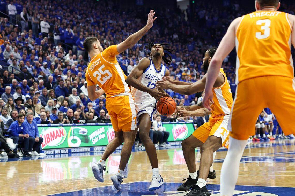 Kentucky guard Antonio Reeves (12) drives to the basket against Tennessee guard Santiago Vescovi (25) during the game at Rupp Arena on Saturday.