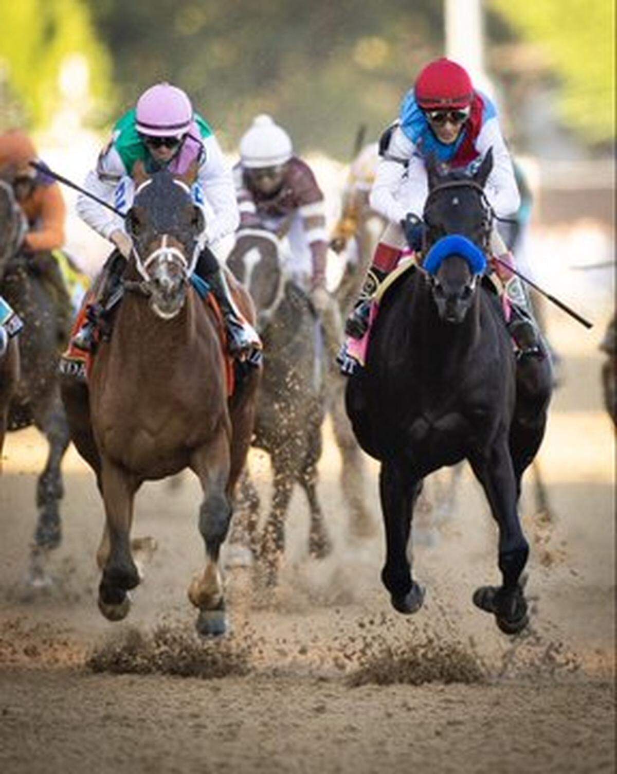 John Velazquez and Medina Spirit, right, crossed the finish line ahead of Mandaloun and Florent Geroux to win the 147th Kentucky Derby.