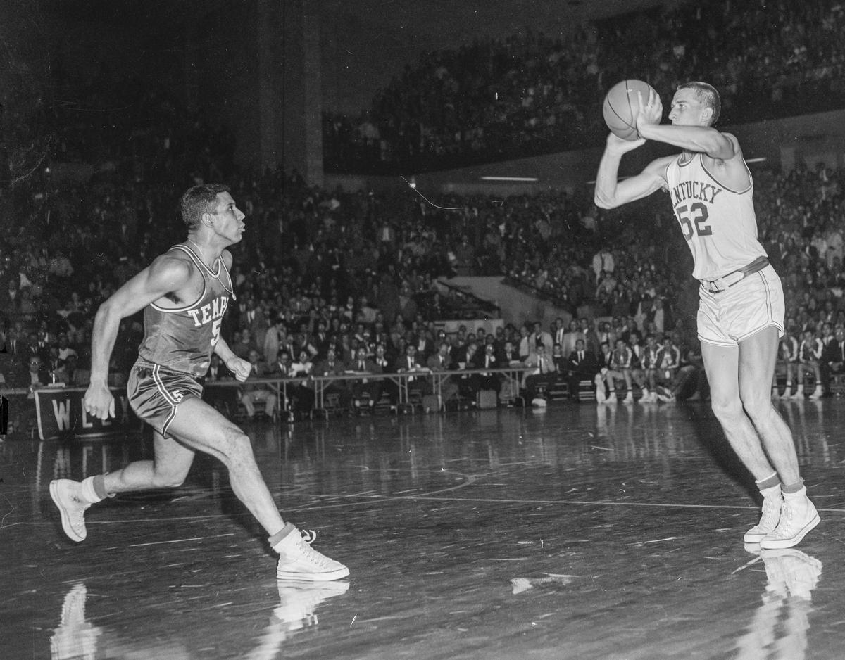 Kentucky guard Vernon Hatton put up a 47-foot shot with one second left in the first overtime to tie Temple, 71-71, as the Owls’ Guy Rodgers, left, was too late to block the shot. UK defeated Temple in triple overtime, 85-83, in Memorial Coliseum on Dec. 7, 1957.