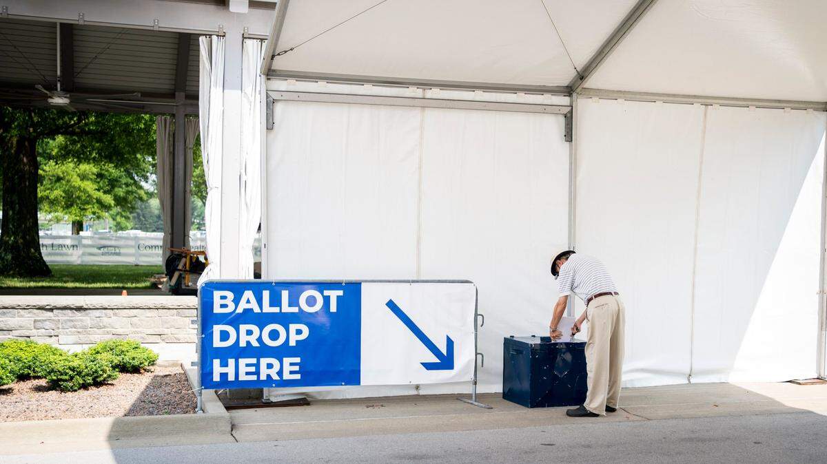 Jim Warren drops his ballot off at a drive-up station outside of Kroger Field in Lexington, Ky., Monday, June 22, 2020.