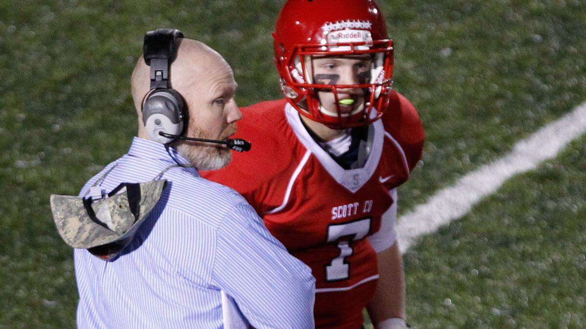Scott County Coach Jim McKee, left, and his son, Clay McKee, will face Meade County in the Class 6A finals. Meade starting QB John Wilson is Clay's cousin.  