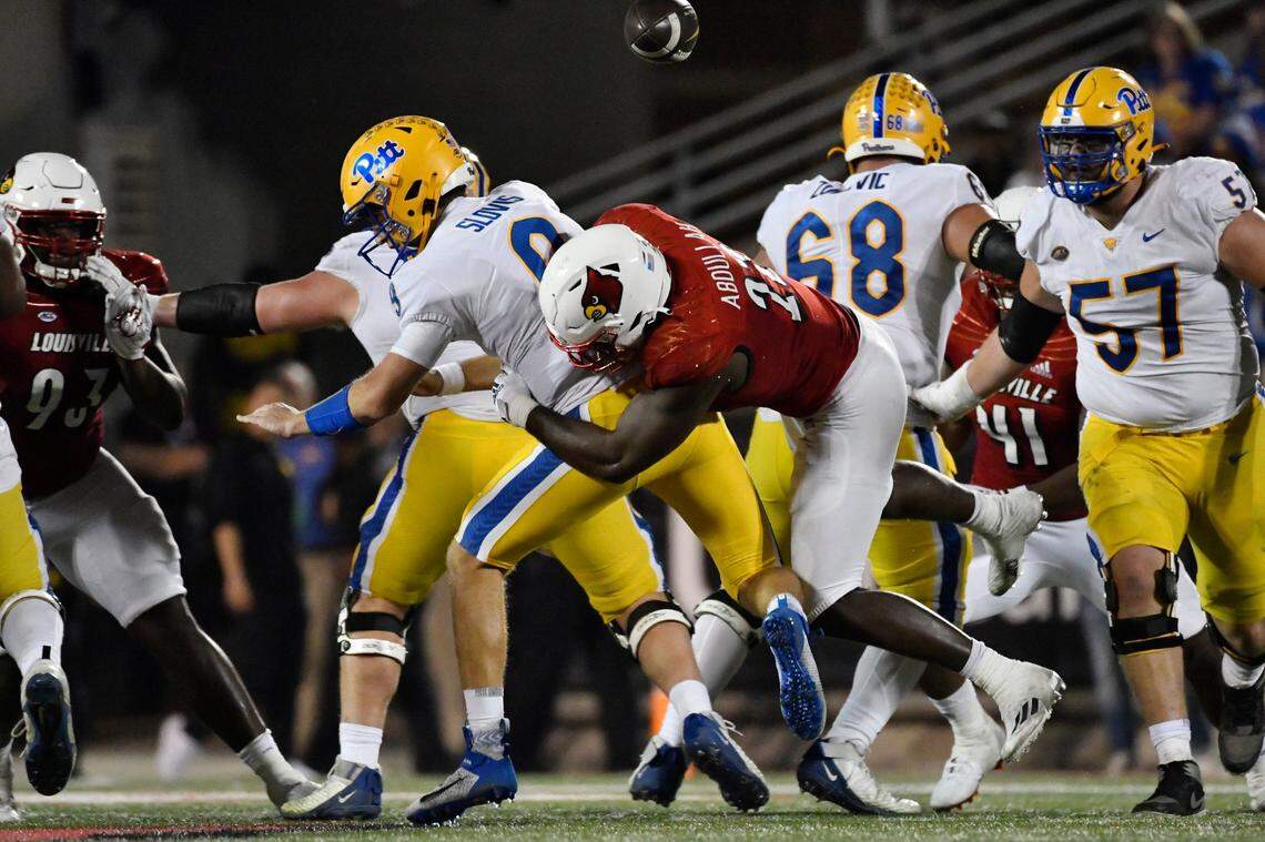 Louisville linebacker Yasir Abdullah (22) hits Pittsburgh quarterback Kedon Slovis (9) in the backfield to force a fumble during U of L’s 24-10 victory over Pitt on Oct. 22. Abdullah has 13 tackles for loss and eight quarterback sacks in 2022.