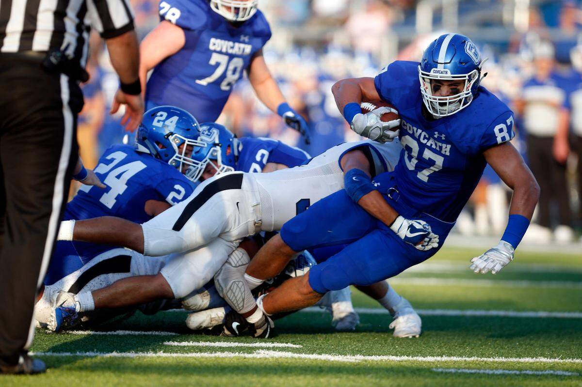 A Lexington Catholic defender tackled Covington Catholic’s Michael Mayer during their game in Park Hills on Sept. 6. The Colonels won 39-38. Mayer, a Notre Dame commit, leads CovCath in the Class 5A state title game on Saturday.