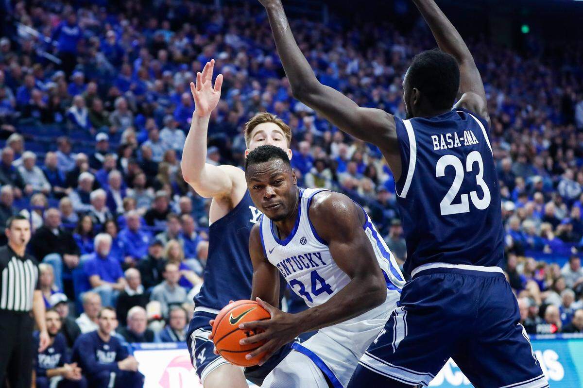 Kentucky’s Oscar Tshiebwe (34) is guarded by Yale’s Yussif Basa-Ama (23) during Saturday’s game in Rupp Arena. Tshiebwe led all scorers with 28 points, two short of his career high.