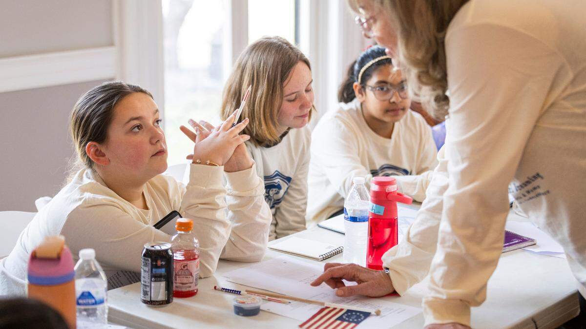 Writing teacher Jaqueline Hamilton, right, worked with girls at the Revolutionary Girl Dreaming Workshop in Lexington last month, learning and writing about Lexington history.