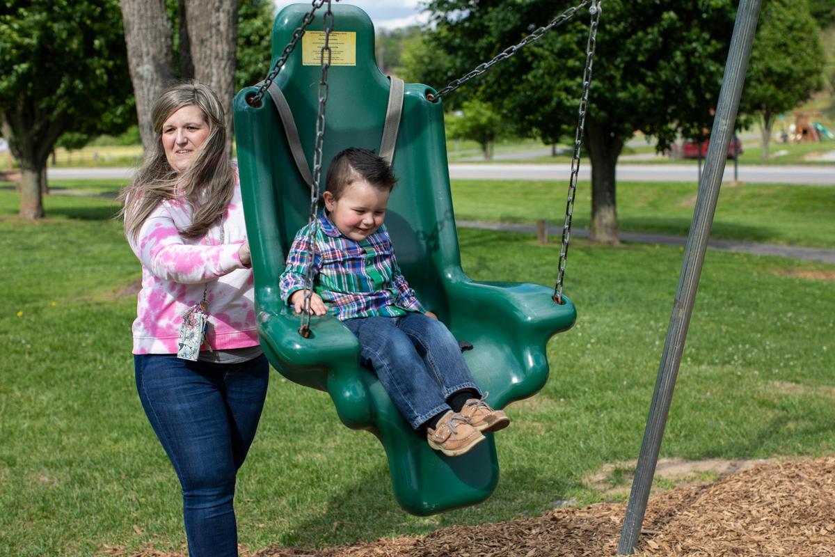 Megan Simpson plays with her son Sawyer on a playground after graduating from Freedom House and returning to live with her family and continue to recover from open heart surgery in Barbourville, Ky., Friday, May 7, 2021.