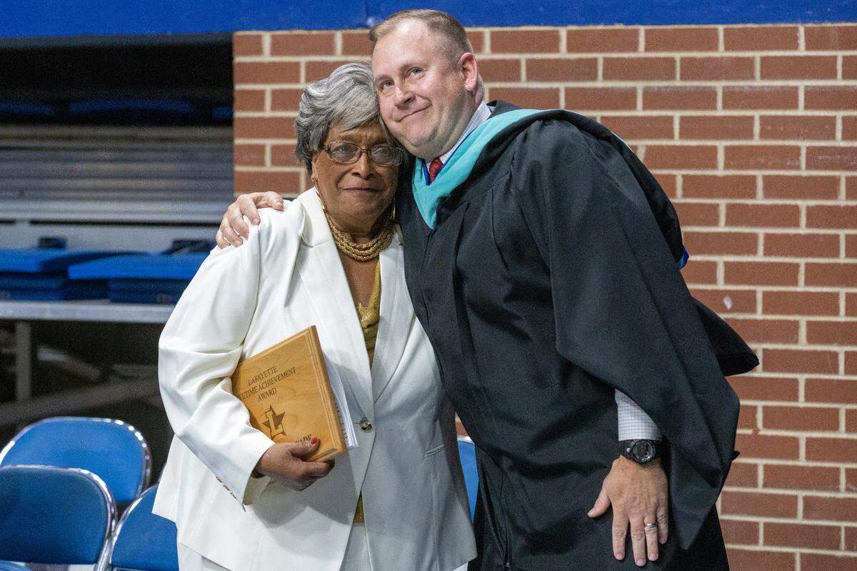Alumna Helen Caise Wade hugs Lafayette High School principal Bryne Jacobs while receiving the Lifetime Achievement Award during the commencement ceremony at Rupp Arena, May 27, 2022. Helen was recognized for being the first African American student to attend a white school in Lexington in 1955.