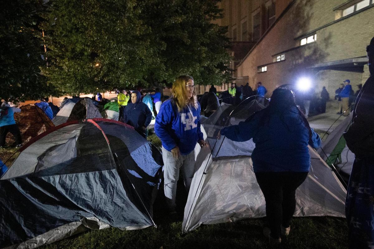 Fans rush to set up tents outside Memorial Coliseum for the Big Blue Madness campout in Lexington early Saturday morning.