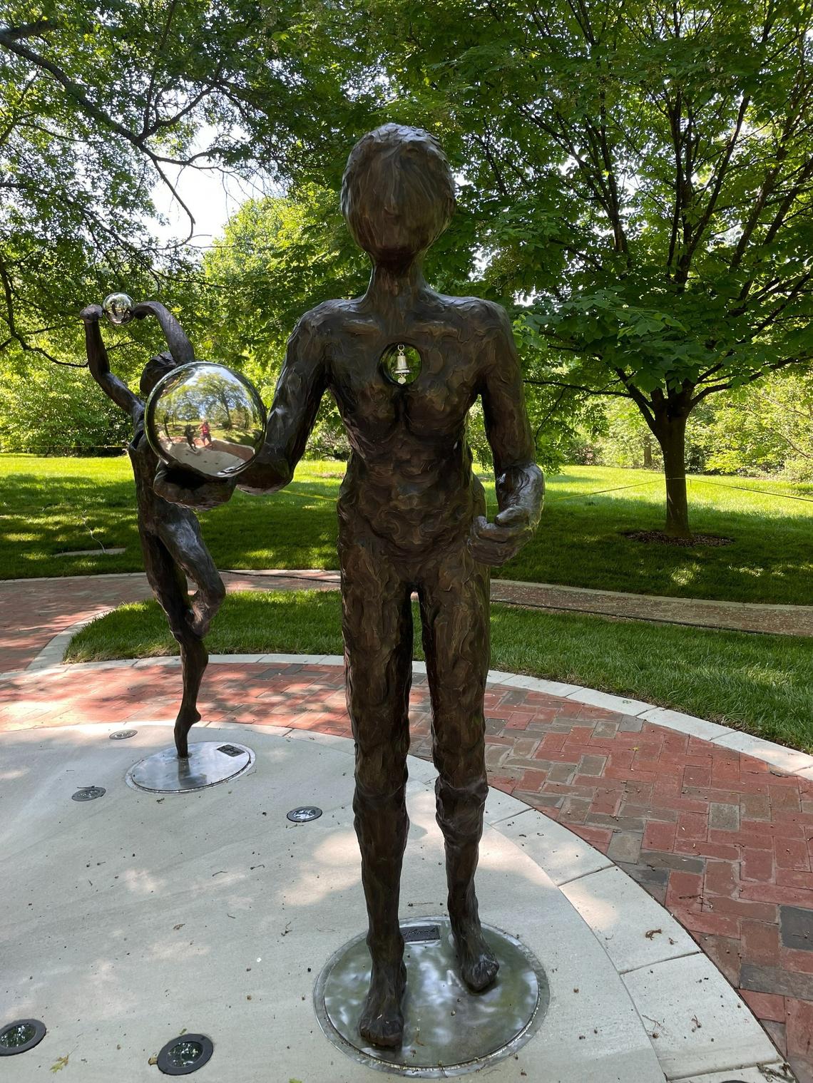 The figures in the Kentucky COVID memorial have holes in their chests to represent loss and bells that can ring in the wind to give a sense of the presence of those lost.