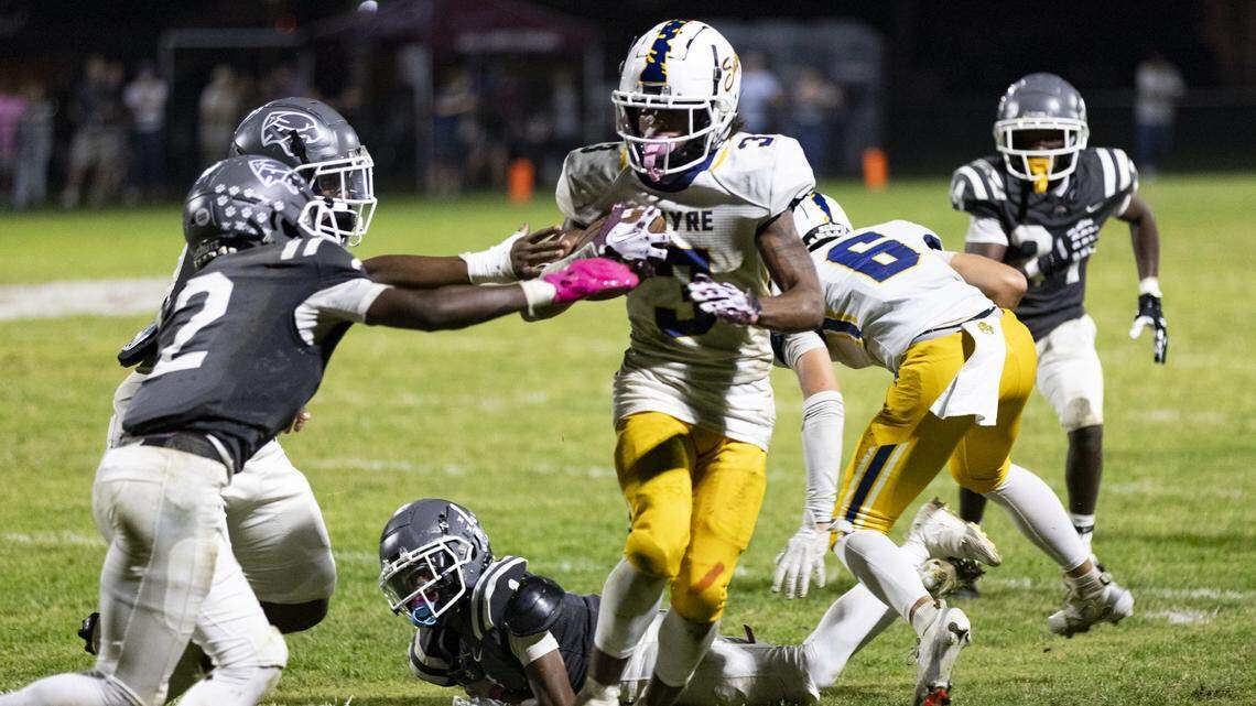 Sayre’s Caden Jones (3) broke through the Louisville Holy Cross defensive line and tried to elude tacklers during the Spartans’ 34-20 win at Holy Cross High School in Louisville on Oct. 3.