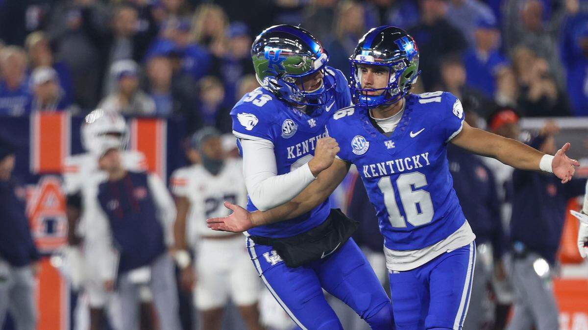Kentucky place-kicker Alex Raynor (16) celebrates with punter Wilson Berry (93) after Rayner made a first-half field goal against Auburn on Oct. 26 at Kroger Field.