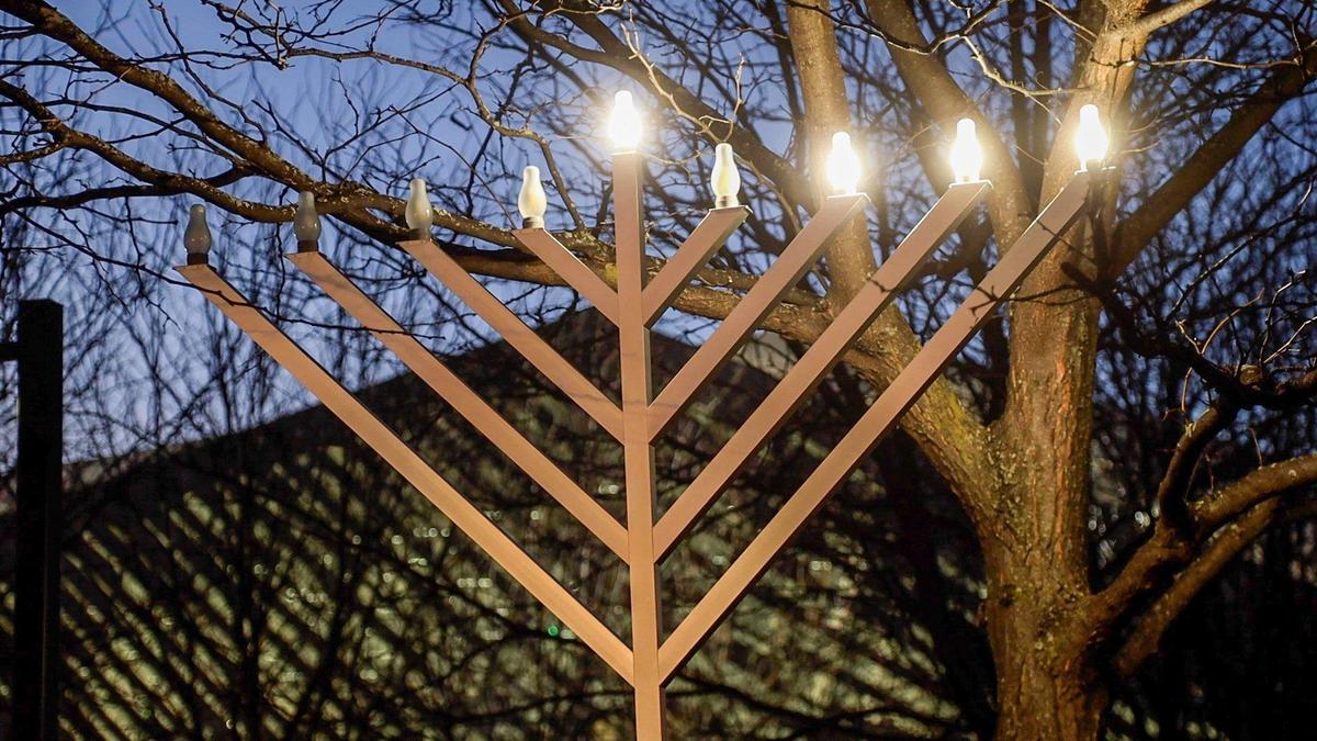 The third candle of a menorah at Triangle Park was lit during the third night of the second annual downtown Hanukkah Celebration on December 20, 2022.