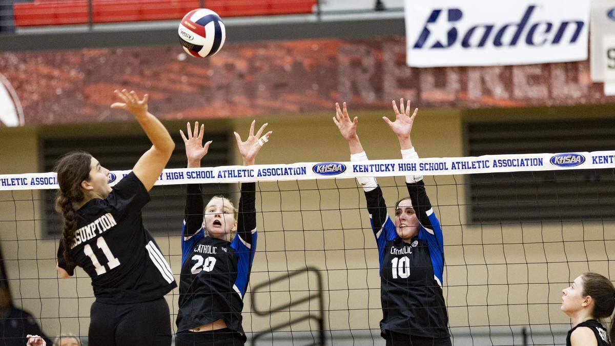 Assumption’s Carle Hooe (11) went up for a kill against Lexington Catholic’s Miller Duncan (20) and Payton Avilez (10) during the KHSAA Girls State Volleyball Tournament semifinals at George Rogers Clark High School in Winchester on Saturday.