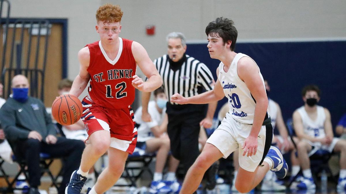 St. Henry’s Wyatt Vieth (12) dribbled down court past Lexington Catholic’s Ryan Russell (20) during their game at Lexington Catholic High School in Lexington, Ky., Thursday, Jan. 7, 2021. Lexington Catholic beat St. Henry 80-78 in overtime. St. Henry won its second consecutive All “A” Classic on Saturday.