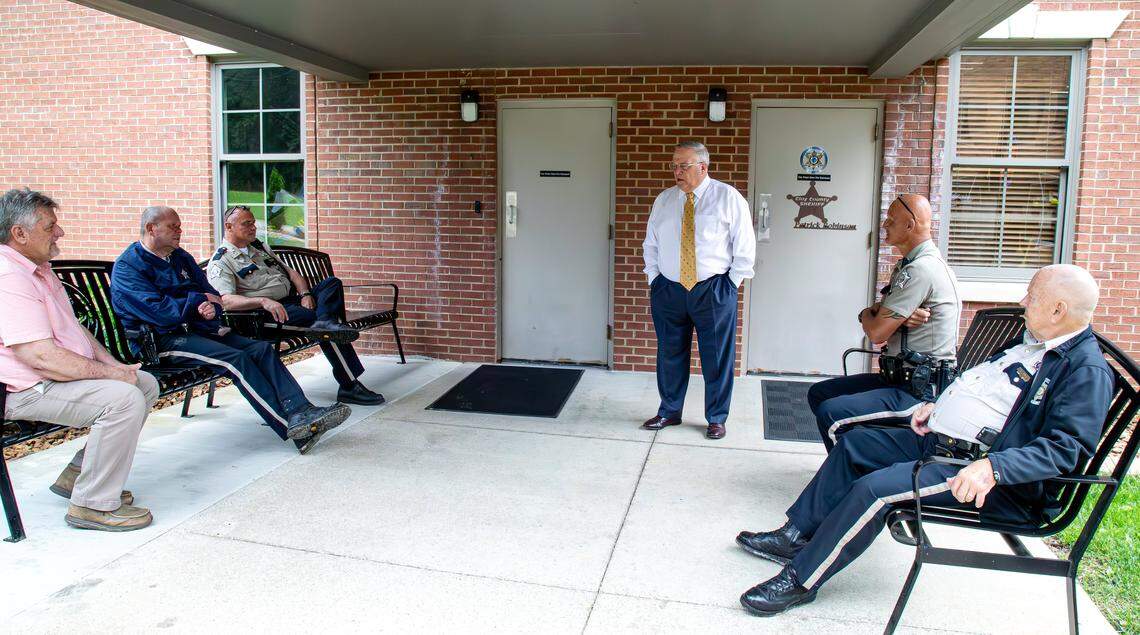 Kentucky Senate President Robert Stivers, R-Manchester, stops to catch up and share family stories with Clay County Sheriff's Department officers, on May 28, 2025, in Manchester, Ky.