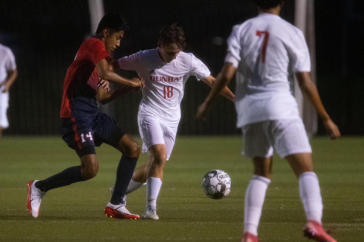 Dunbar’s Kasen Johnston (18) pushes the ball upfield against Lafayette on Tuesday night. Johnston scored one of the Bulldogs’ six goals during a devastating 21-minute stretch.