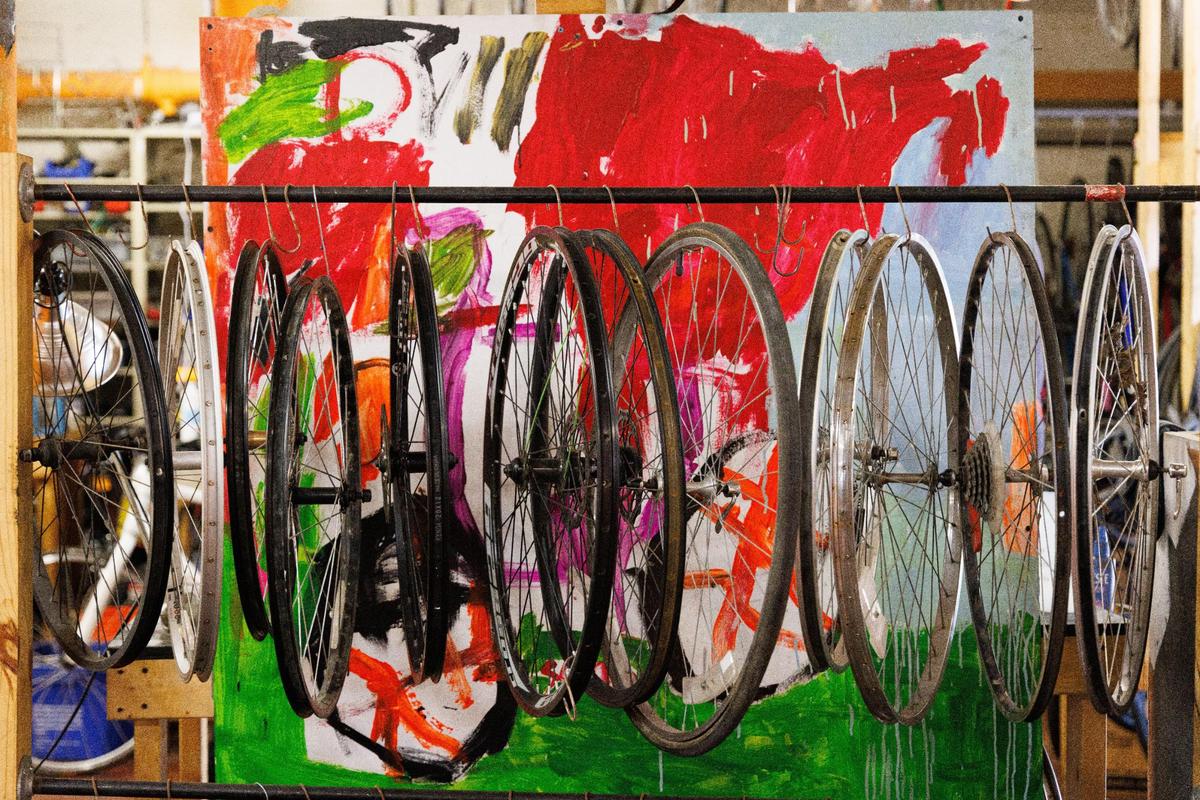 Bicycle wheels are hung from a rack on Sunday, May 22, 2022, at Broke Spoke Community Bike Shop in Lexington, Kentucky.