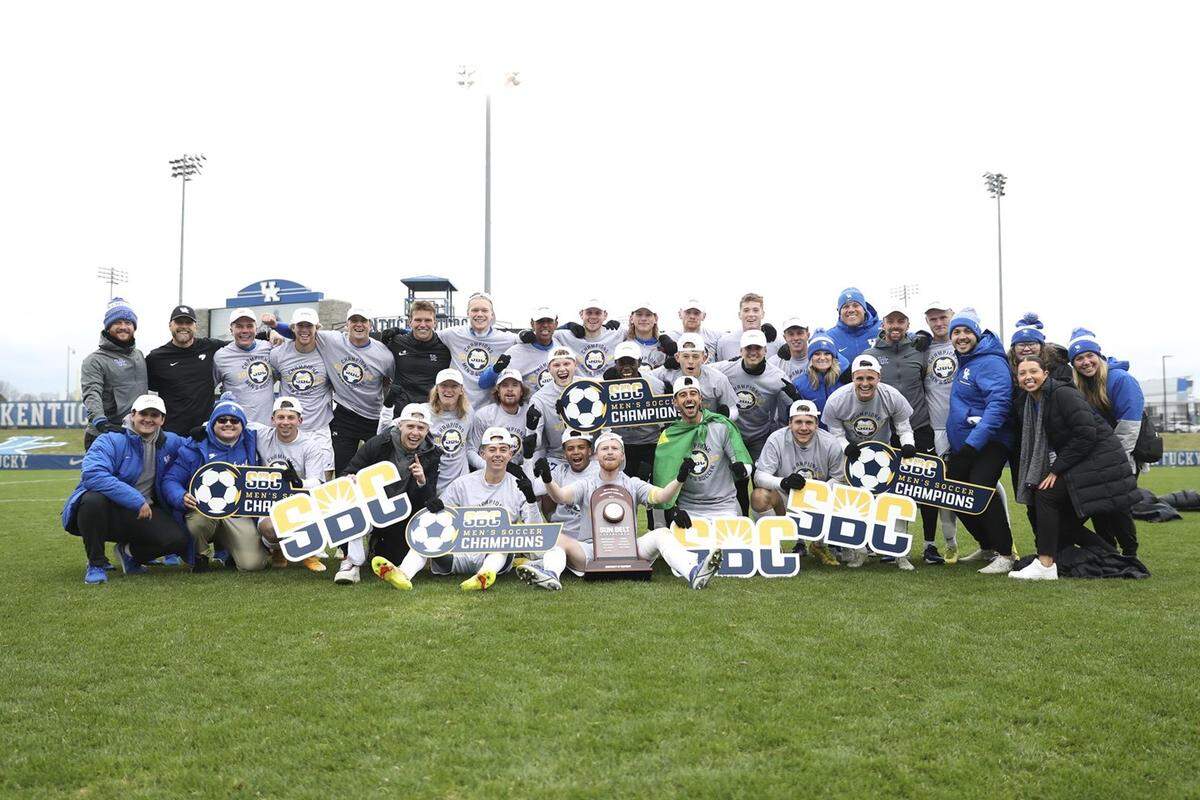 The undefeated Kentucky Wildcats (14-0-5) celebrate with the Sun Belt Conference Tournament championship trophy after Sunday’s 2-0 win in Lexington.