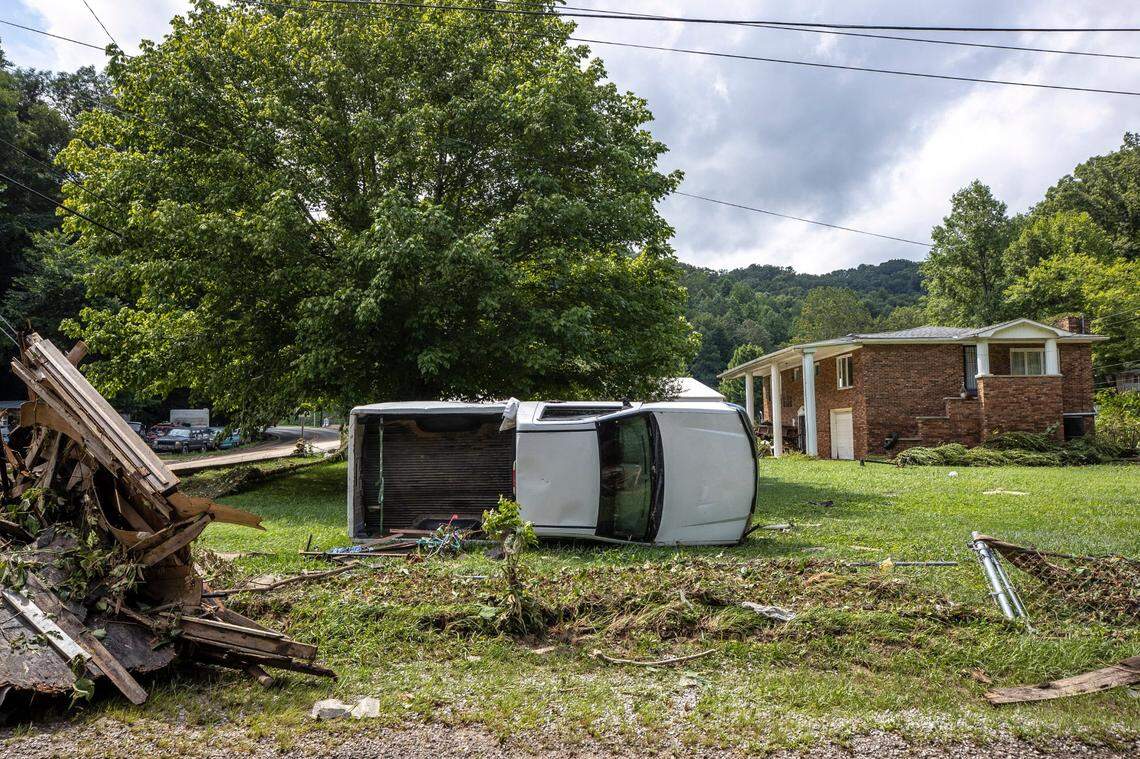 A wrecked truck rests on its side July 28, 2022 in front of a house in Hindman, Ky. from flood damage that ravaged Eastern Kentucky.