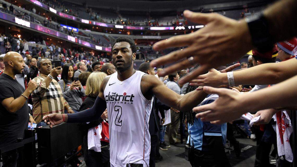 John Wall greeted fans after Game 4 of the Wizards' first-round playoff series against the Raptors on Sunday in Washington.
