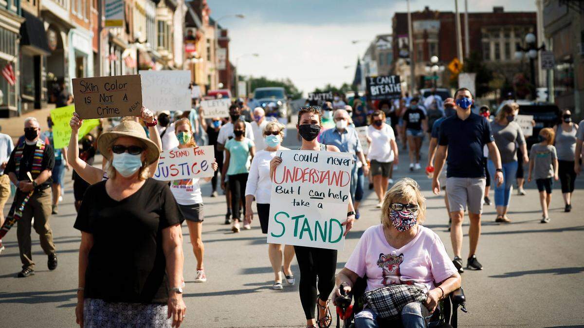 Over 100 people walk along South Main Street during the Together for Justice march in downtown Winchester, Ky., Friday, June 19, 2020. The march began at the Clark County Courthouse and ended at Heritage Park with a Juneteenth ceremony. 