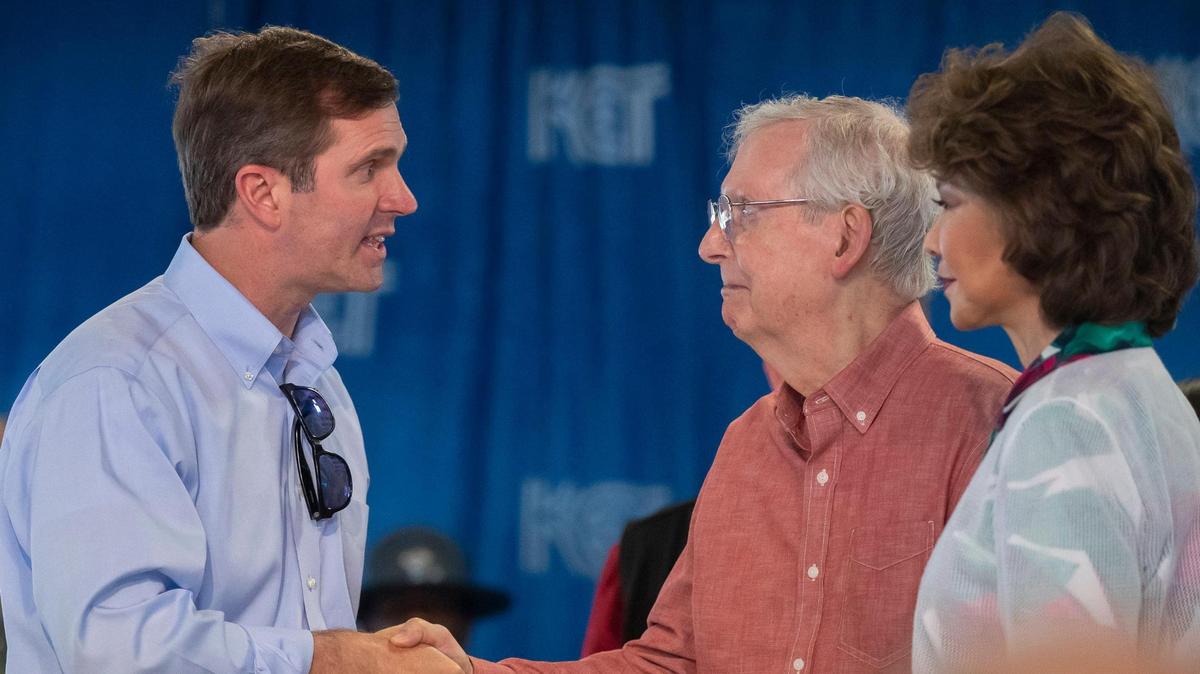 Kentucky Gov. Andy Beshear greets Senate Minority Leader Mitch McConnell (R-Ky.) and his wife, former U.S. secretary of labor and transportation Elaine Chao, at the annual St. Jerome Fancy Farm Picnic in Fancy Farm, Ky., on Saturday, Aug. 5, 2023.