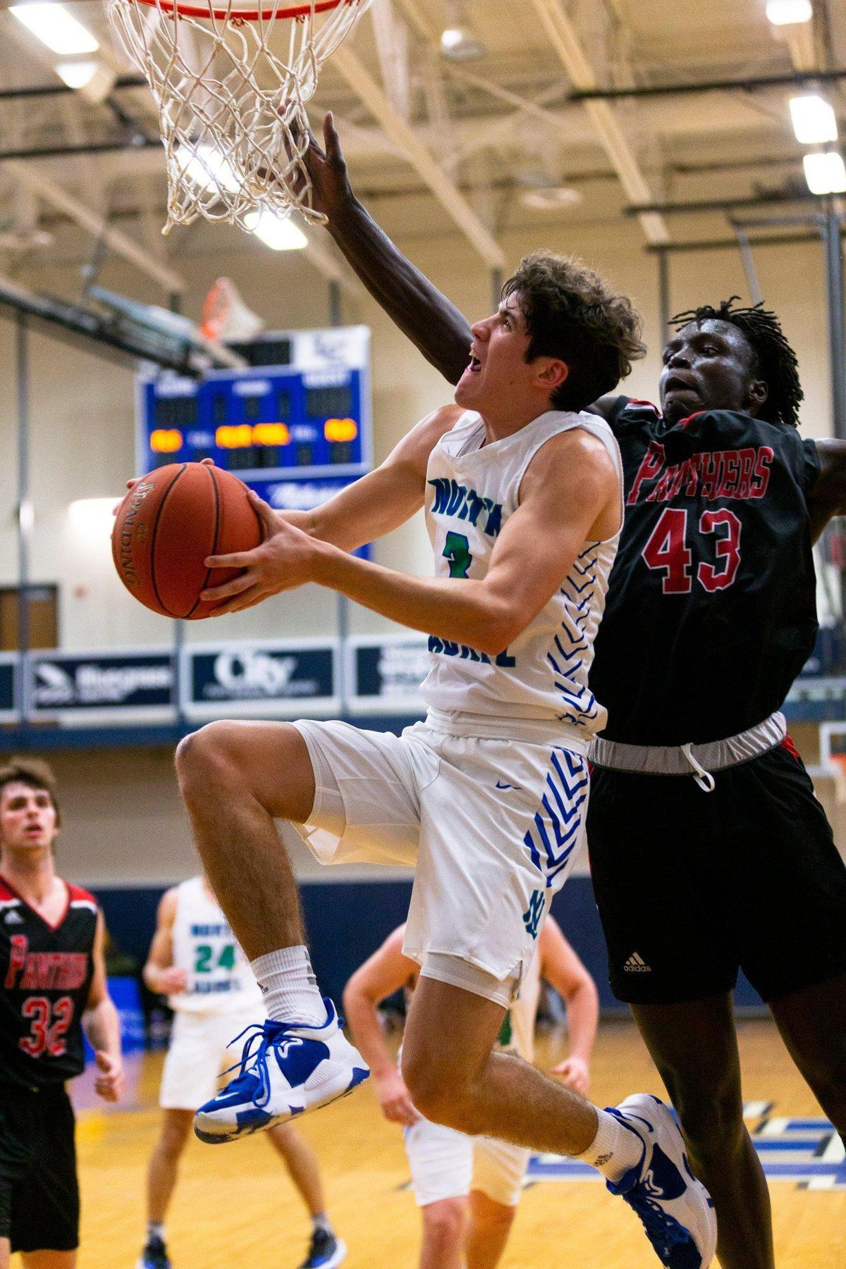 North Laurel’s Reed Sheppard (3) went up and under to score against Pleasure Ridge Park’s Victor Lado (43) on Monday night. Sheppard’s 50 points led the Jaguars to a come-from-behind win in overtime in the quarterfinals of the White, Greer and Maggard Holiday Classic.