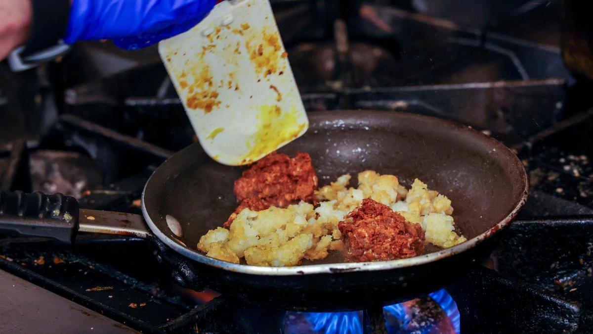 Crushed tater tots and chorizo sausage are used in preparing the DV Ocho at DV8 Kitchen. The popular tots are used in several menu items.